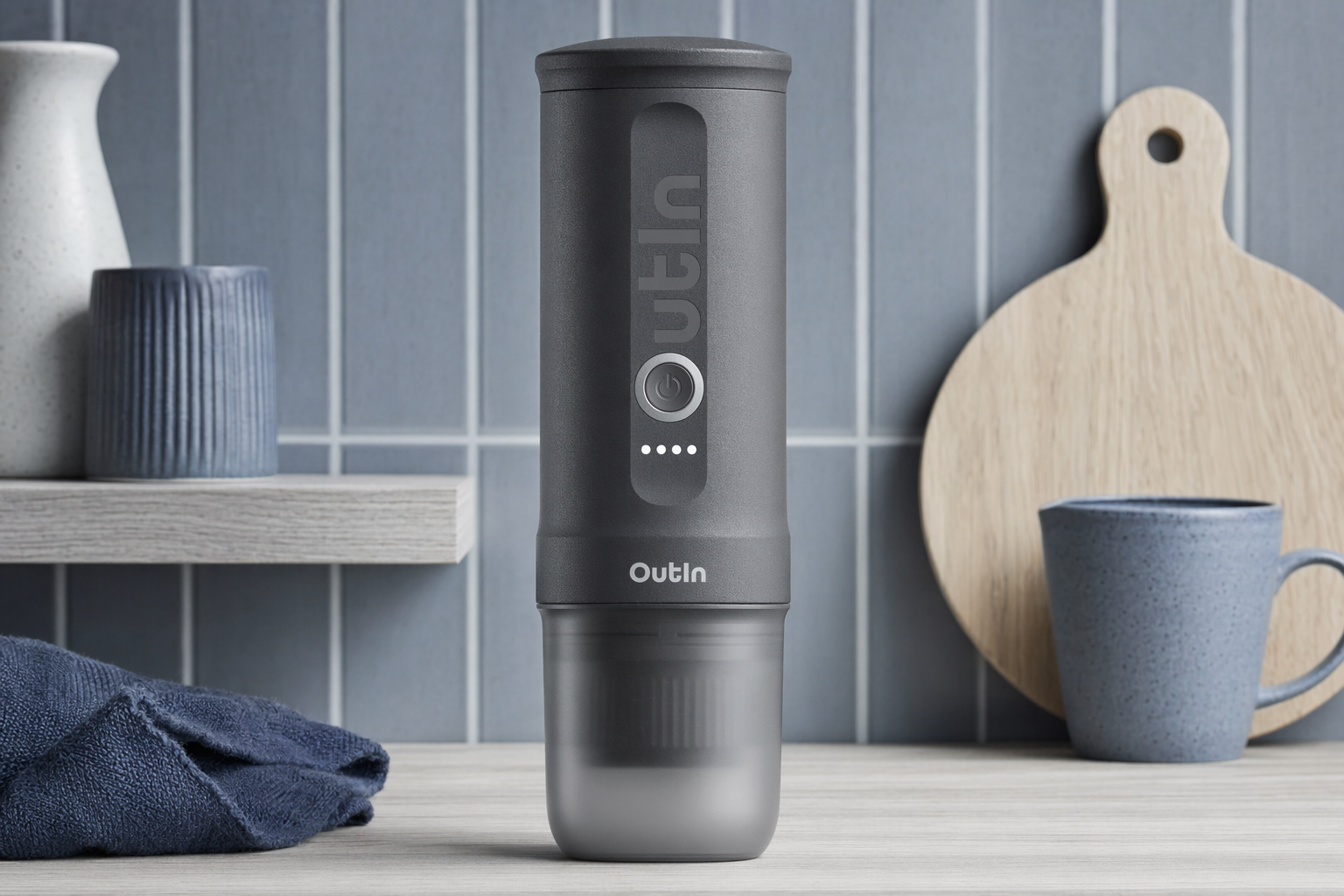 OutIn Nano portable espresso maker on a hotel desk